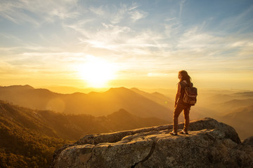 Hiker meets the sunset on the Moro rock in Sequoia national park, California, USA.