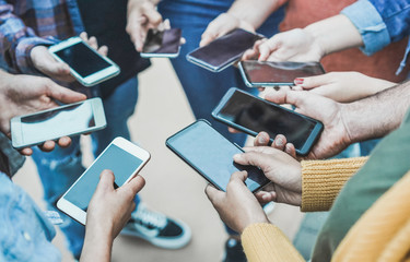 Teenager friends using smartphones outdoor