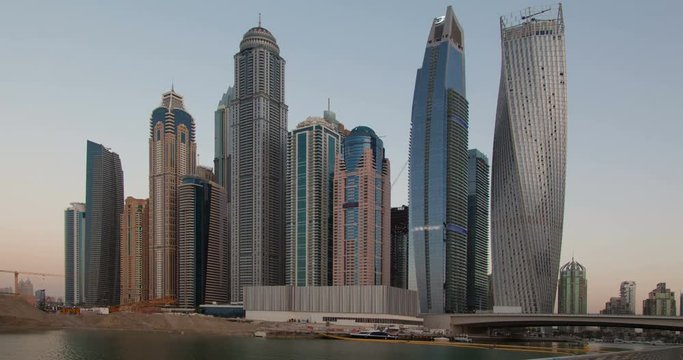 View from Promenade on Dubai Marina modern Towers from day to night. Time Lapse.