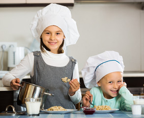 Small girls eating healthy oatmeal