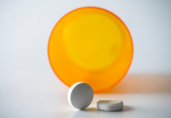 Tablets with isolated bottle on white background, conceptual image
