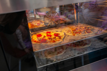 two pizzas in the oven