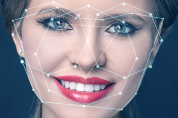 technological scanning of a young woman's face. face tracking. secret control. face scan. smiling girl