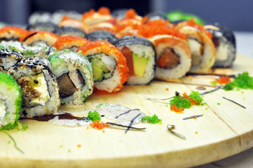 Sushi set: sushi roll with salmon and sushi roll with smoked eel, selective focus.