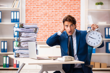 Young elegant man unhappy with too much work 