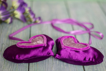 Valentine's Day with purple hearts on the blue wooden table