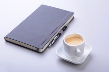 office table with notebook, computer keyboard,, cup of coffee, tablet pc. copy space.