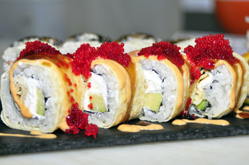 Sushi set: sushi roll with salmon and sushi roll with smoked eel, selective focus.
