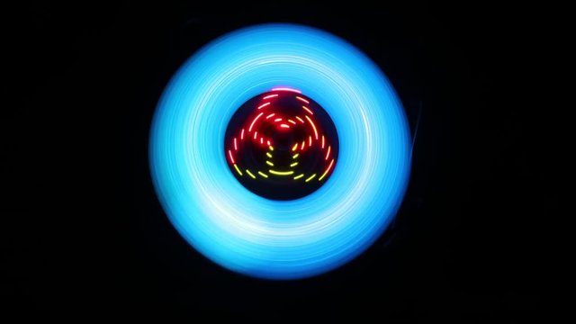 Music Dj concept. Trail of fire and smoke on vinyl record. Burning vinyl disk. Turntable vinyl record player on dark background. Selective focus