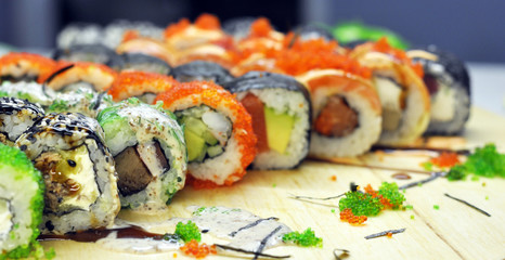 Sushi set: sushi roll with salmon and sushi roll with smoked eel, selective focus.