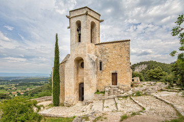 Fototapeta na wymiar View of the Landscape of Luberon with the Church of Notre Dame Dalidon in the village Oppede le Vieux, Provence, Luberon, Vaucluse, France