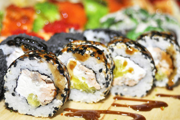 Sushi set: sushi roll with salmon and sushi roll with smoked eel, selective focus.