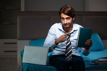 Tired businessman working overtime at home at night