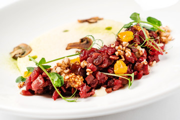 plate with delicious tartare and mushroom puree. Isolated on the white background