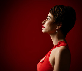 Fototapeta na wymiar Close up portrait of a professional short hair business woman on red 