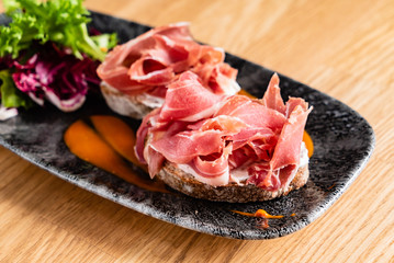 Sandwich with prosciutto, cheese and lettuce