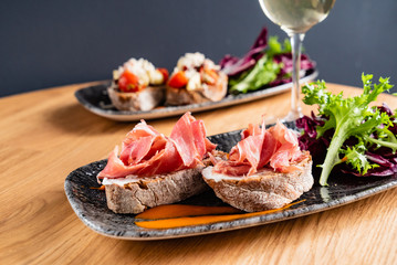 Sandwich with prosciutto, cheese and lettuce