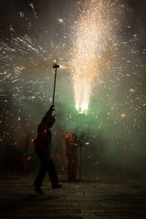Fototapeta na wymiar Typical Correfocs of Catalonia, a type of fireworks managed by men dressed as devils