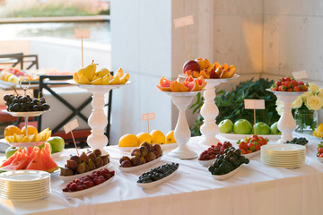 Fototapeta na wymiar Banquet table full of fruits and berries