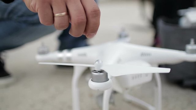 Male hand installs a propeller to the drone