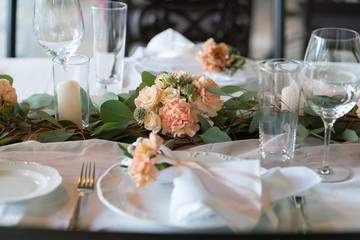 table decorated with fresh flowers and candles for a wedding dinner