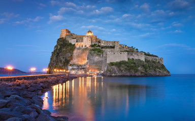 Sunset view of Aragonese Castle near Ischia island, Italy - obrazy, fototapety, plakaty