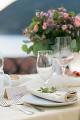 table decorated with fresh flowers for an outdoor wedding dinner