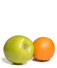 green apple and one orange on white background