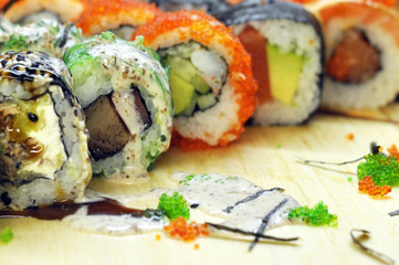 Sushi set: sushi roll with salmon and sushi roll with smoked eel, selective focus.