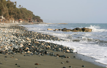 Fototapeta na wymiar Empty beach with pebbles, sand and waves