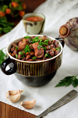 Cooked legumes meat in a bowl on an old wooden table. National dish Asia, Europe, America