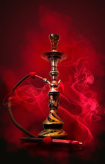 Hookah smoking on a red background of an empty room neon light, smoke, smog