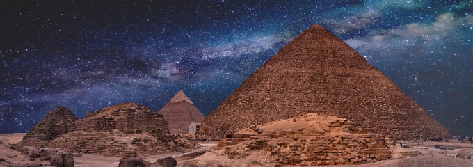 Night sky of the Milky Way over the great pyramids on the plateau of Giza, Egypt, Africa.