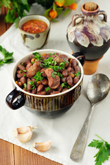 Cooked legumes meat in a bowl on an old wooden table. National dish Asia, Europe, America