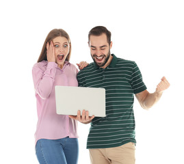 Emotional young people with laptop celebrating victory on white background
