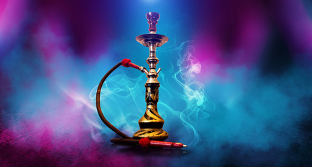 Smoking hookah on the background of an empty room. Multicolored neon light. Searchlight, laser blue and pink rays, smoke. - obrazy, fototapety, plakaty