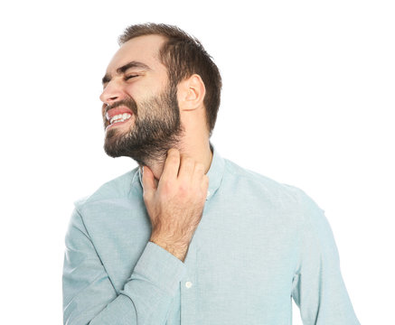 Young man scratching beard on white background. Annoying itch