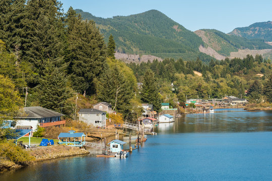 Houses, piers and boats on a shore of a lagoon near Twin Rocks, Oregon, USA.