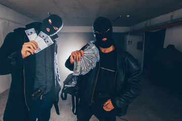 Men in black holding money