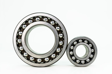 Small and large ball bearing close up, isolated on white background with clipping path.