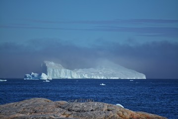 Ilulissat, Greenland, July | UNESCO world heritage site | impressions of Jakobshavn | Disko Bay Kangia Icefjord | huge icebergs in the blue sea on a sunny day | climate change - global warming