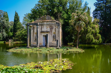 Pond with ancient building in English garden in the royal palace of Caserta