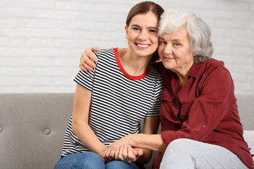 Elderly woman with female caregiver at home