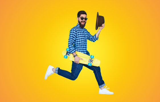 Hipster in motion on yellow background