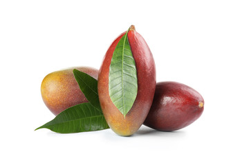 Delicious ripe mangoes on white background. Tropical fruit