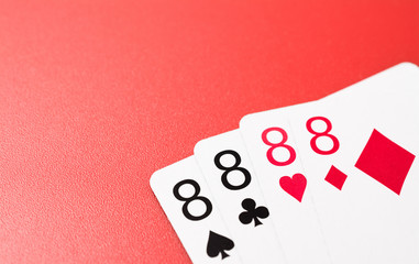 four eight playing cards abstract on a red background