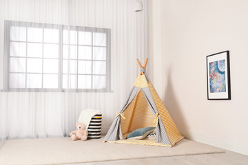 Cozy child room interior with play tent near window © New Africa