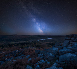 Stunning vibrant Milky Way composite image overBeautiful Autumn sunset landscape image of view from Leather Tor towards Burrator Reservoir in Dartmoor National Park