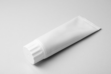 Blank tube of toothpaste on white background