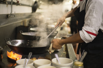 Chef stirring cooking
